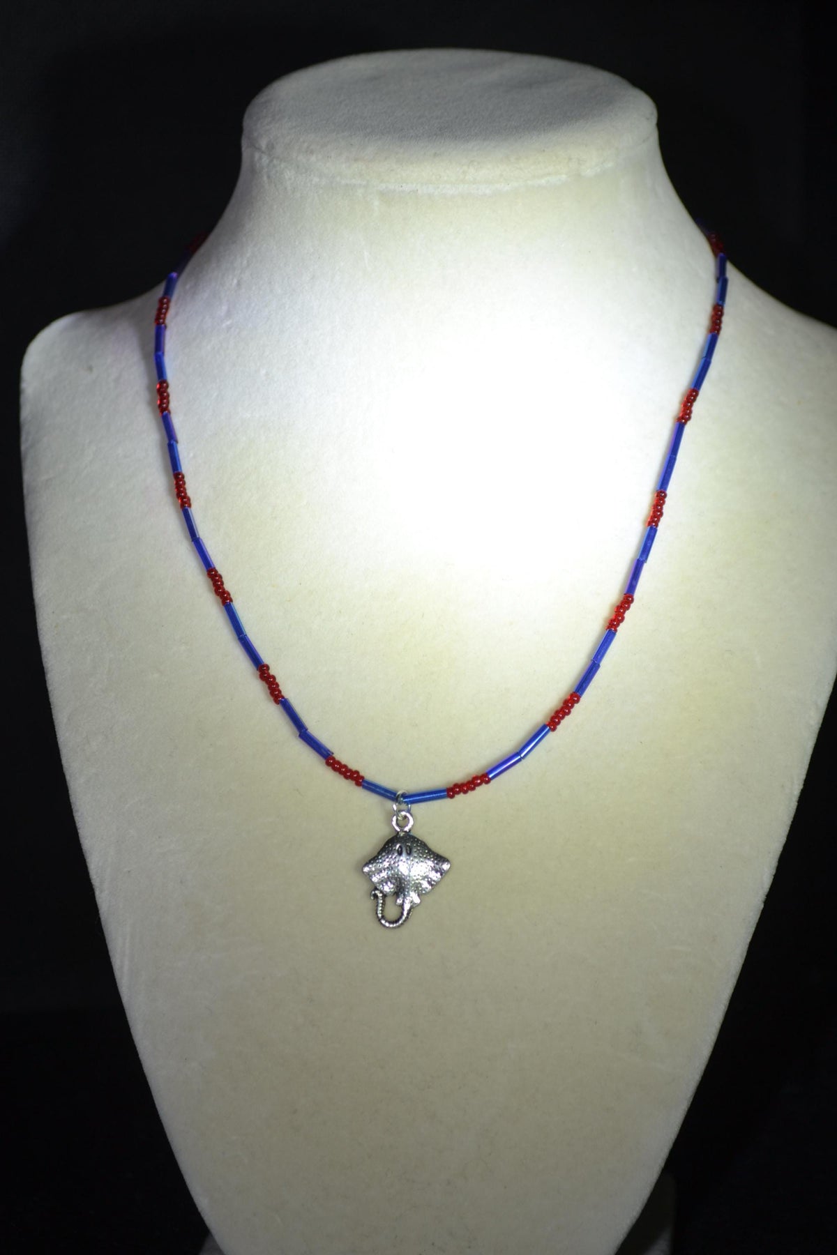 Silver Stingray pendant glass bead necklace. Red and blue
