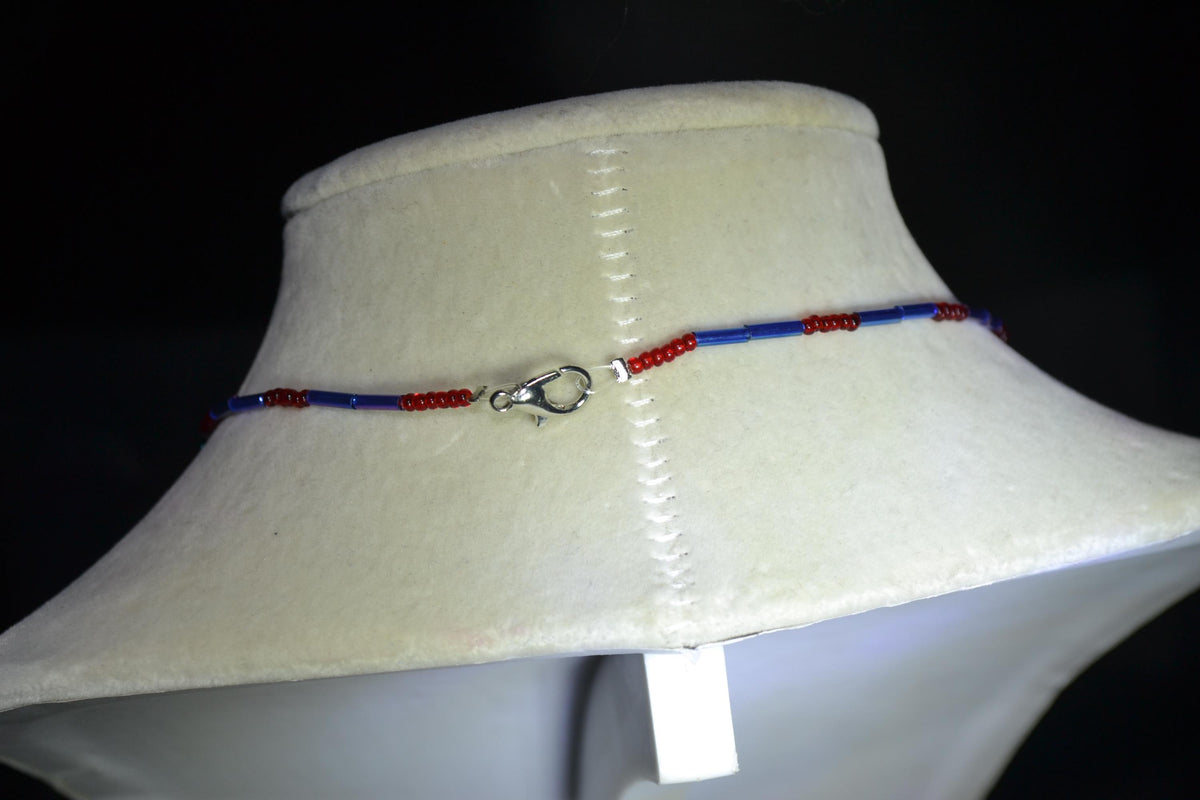 Silver Stingray pendant glass bead necklace. Red and blue