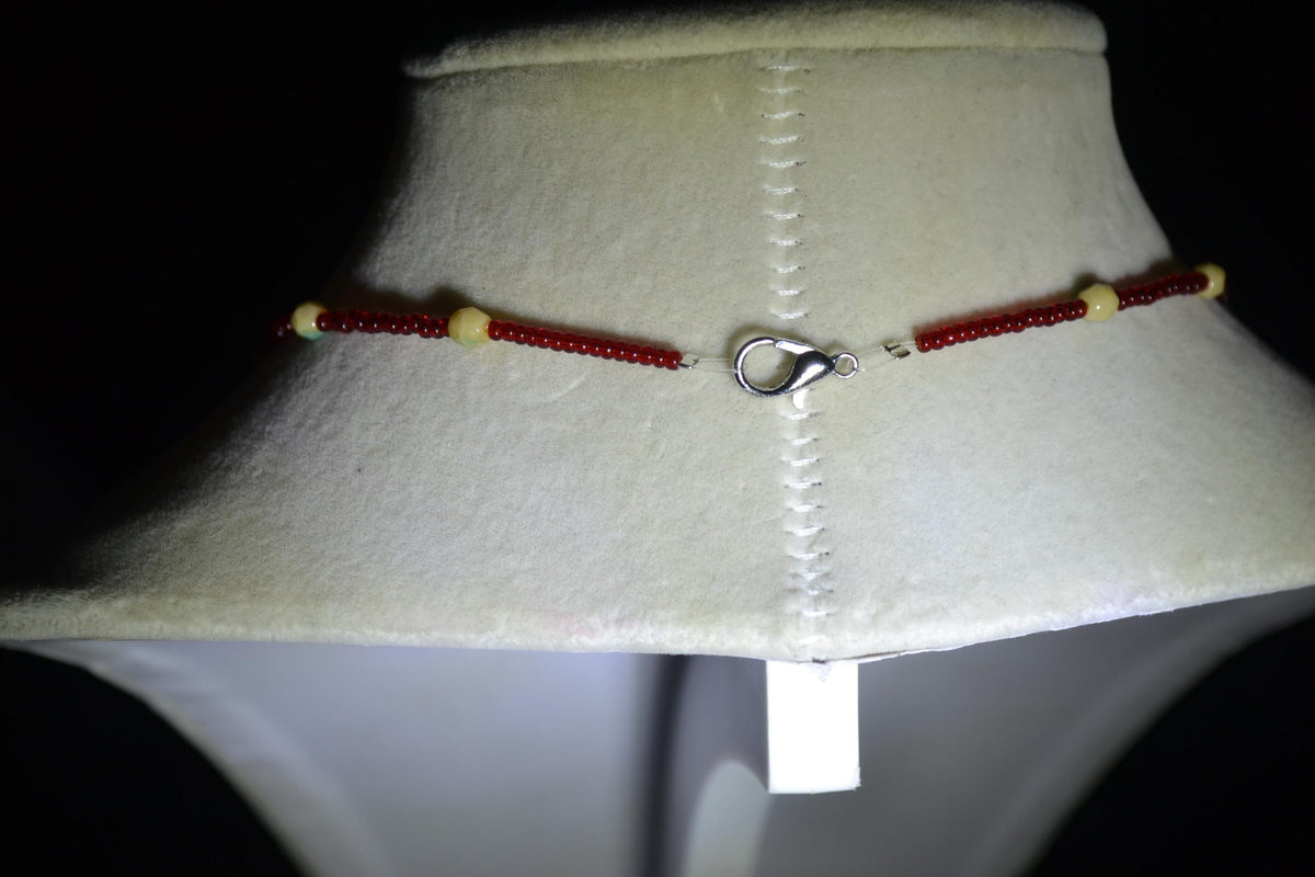 Silver Sun pendant glass bead necklace. Red, cream, and teal