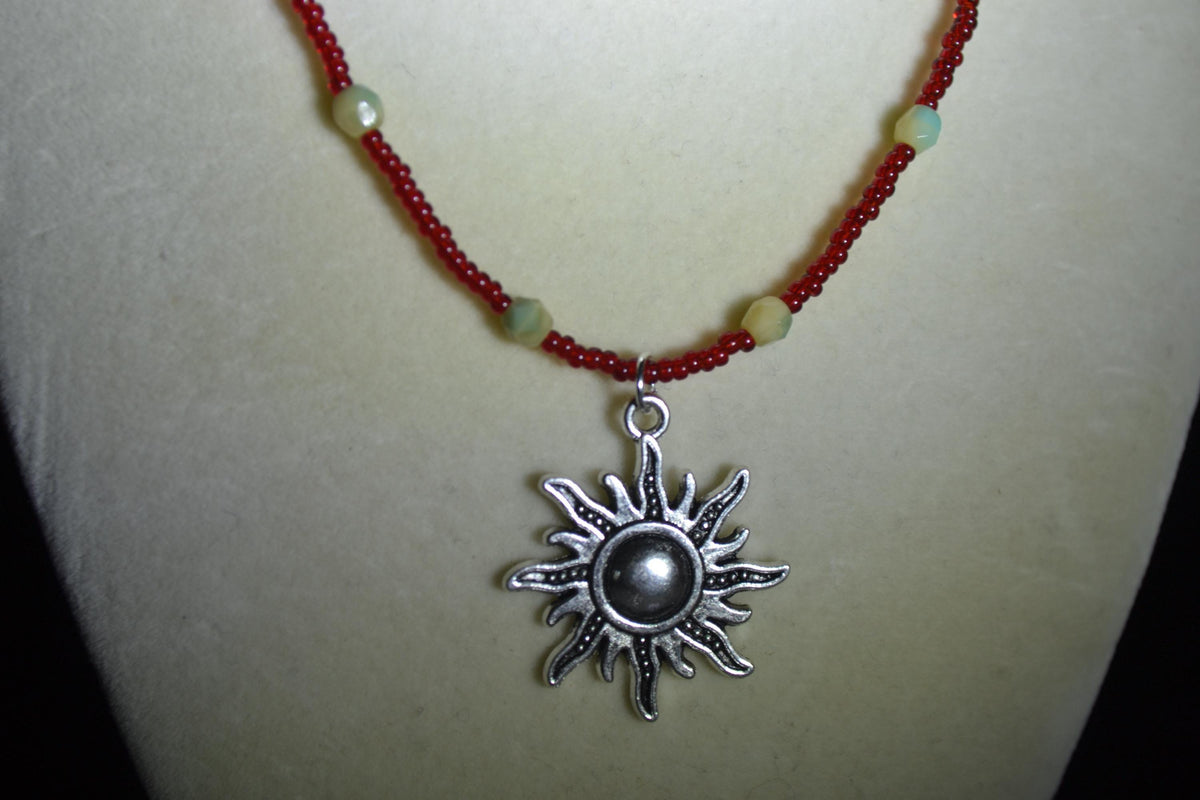 Silver Sun pendant glass bead necklace. Red, cream, and teal