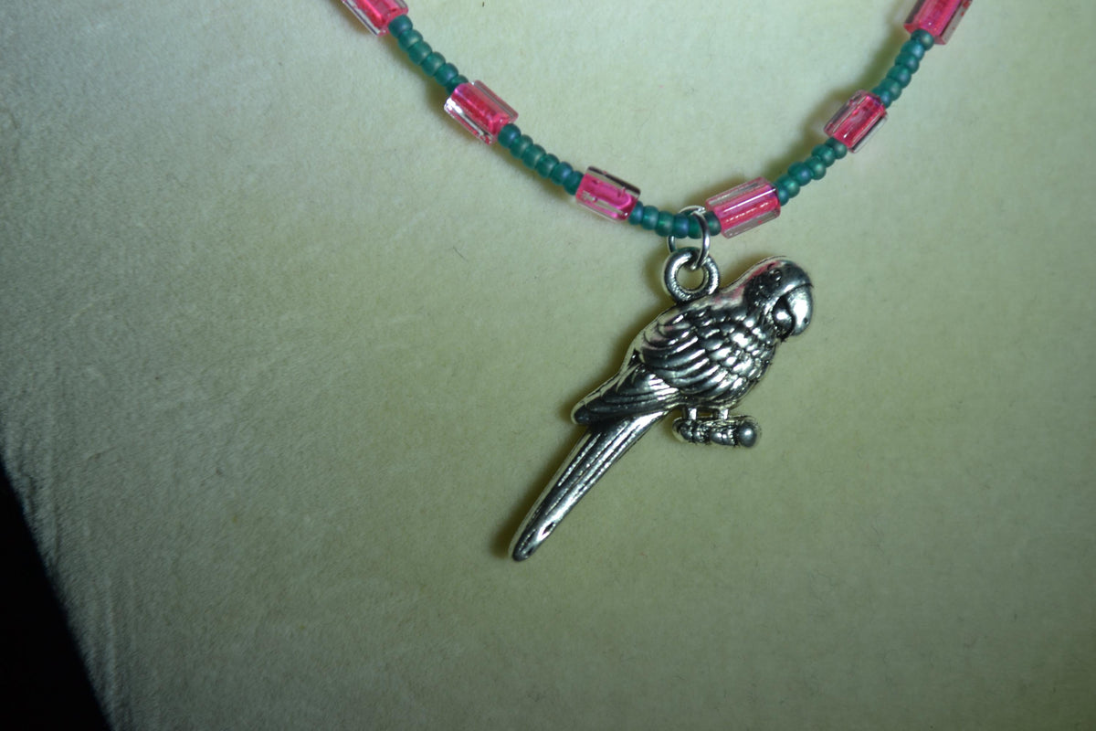 Silver Parrot pendant glass bead necklace. Teal and fuchsia
