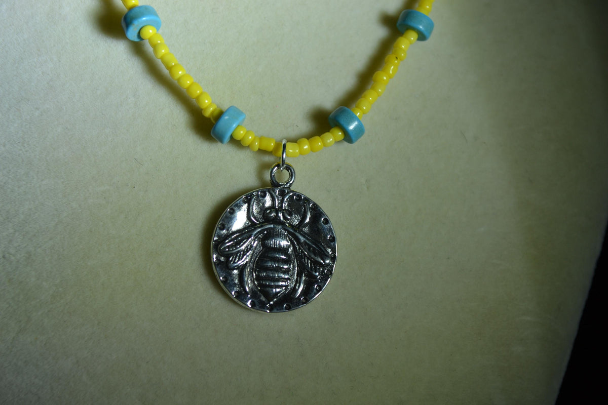 Silver bee pendant glass bead necklace. Turquoise and yellow