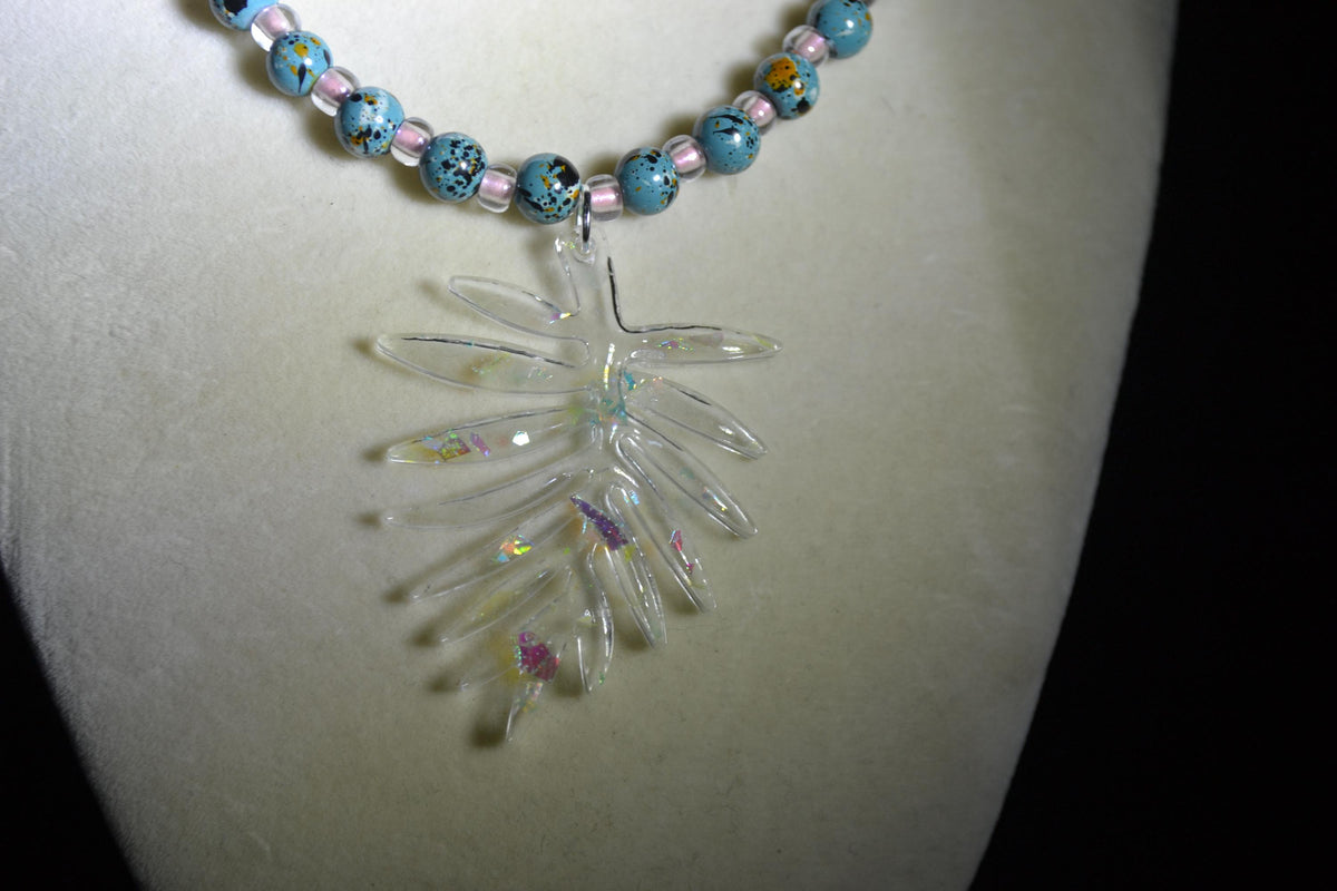 Iridescent philodendron pendant glass bead necklace. Turquoise and pink