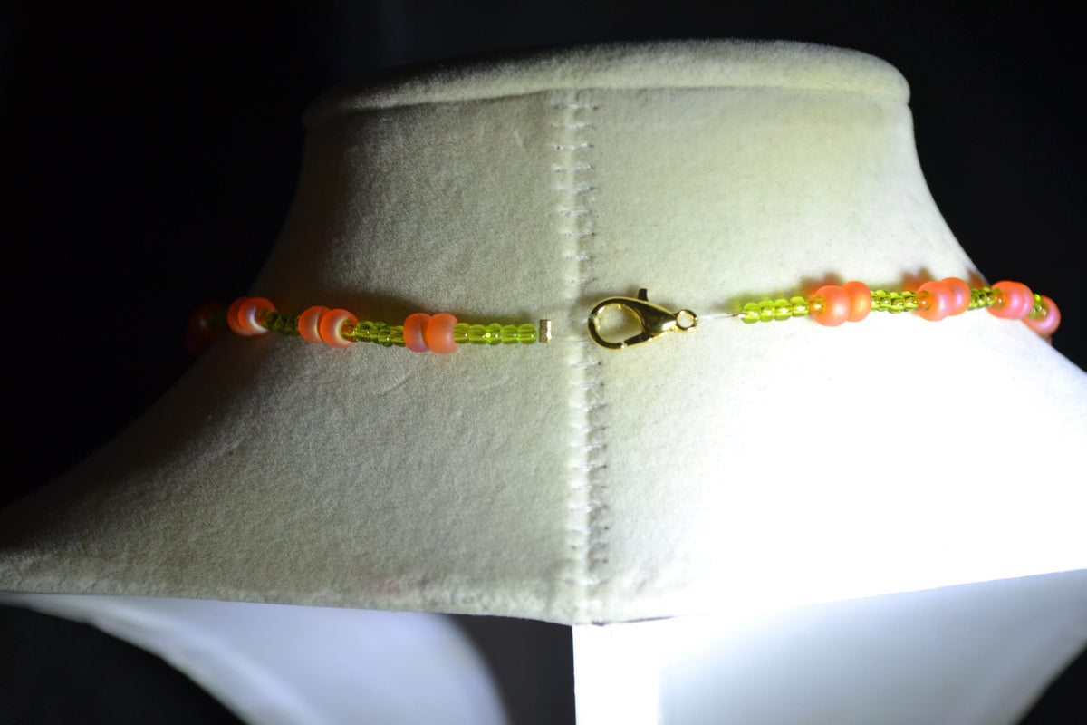 Black butterfly pendant glass bead necklace. Green and coral