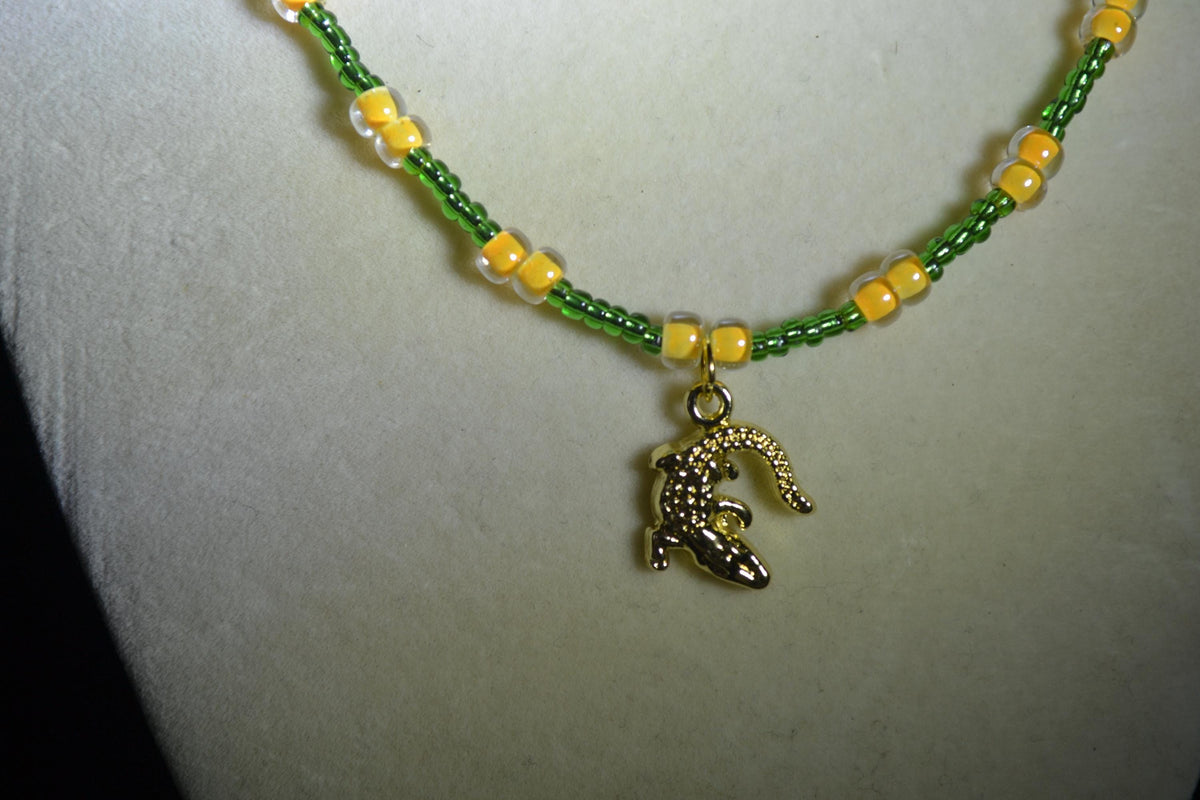 Gold alligator pendant glass bead necklace. Green and yellow