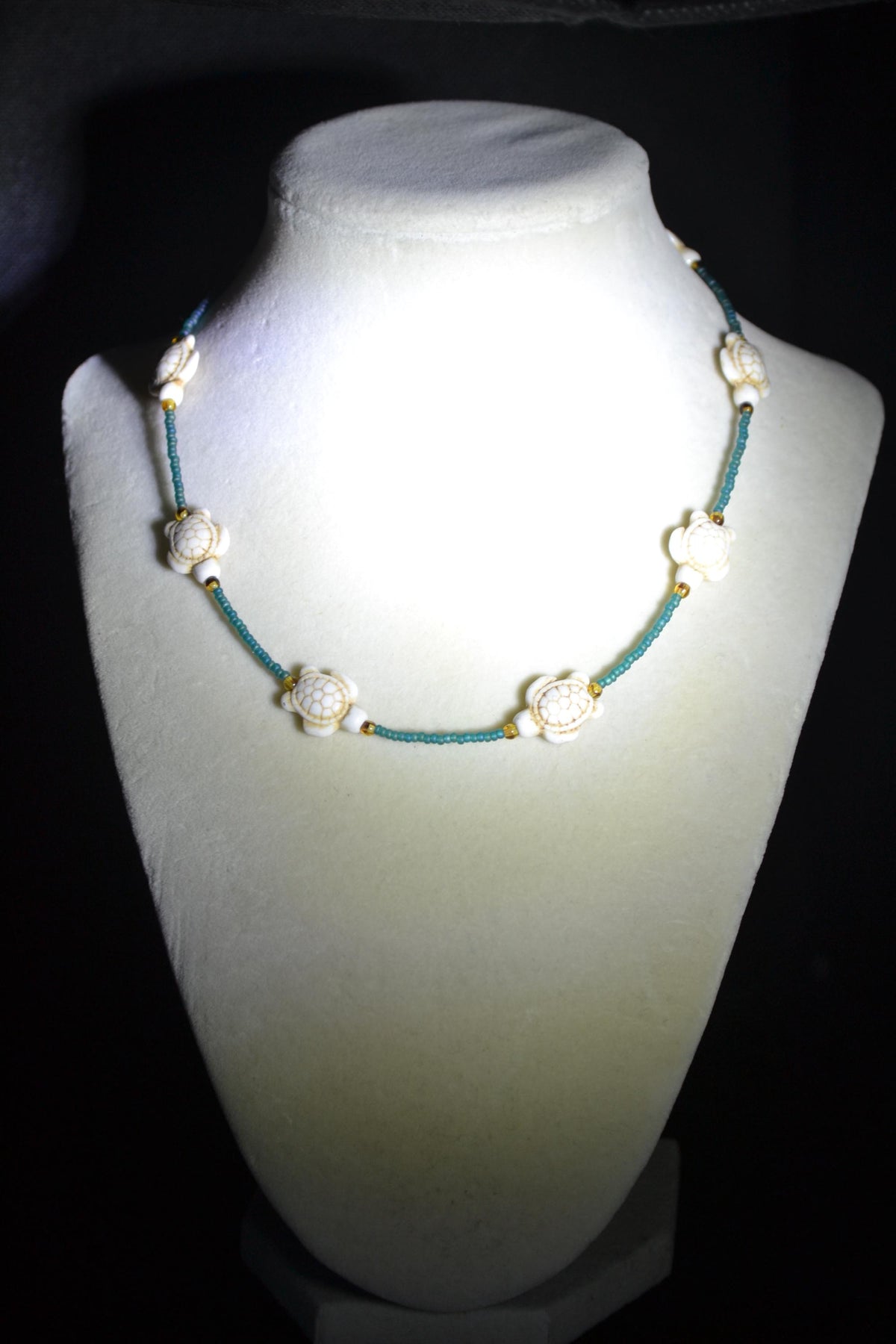 Multicolor glass bead necklace. White turtles, teal, and brown tortoise