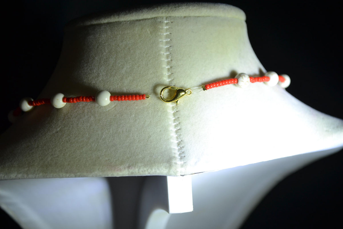 Gold cross pendant glass bead necklace. Red and white