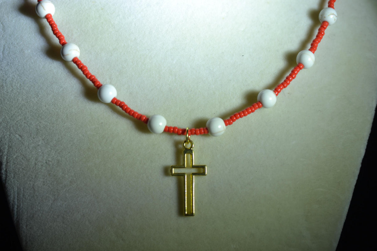 Gold cross pendant glass bead necklace. Red and white