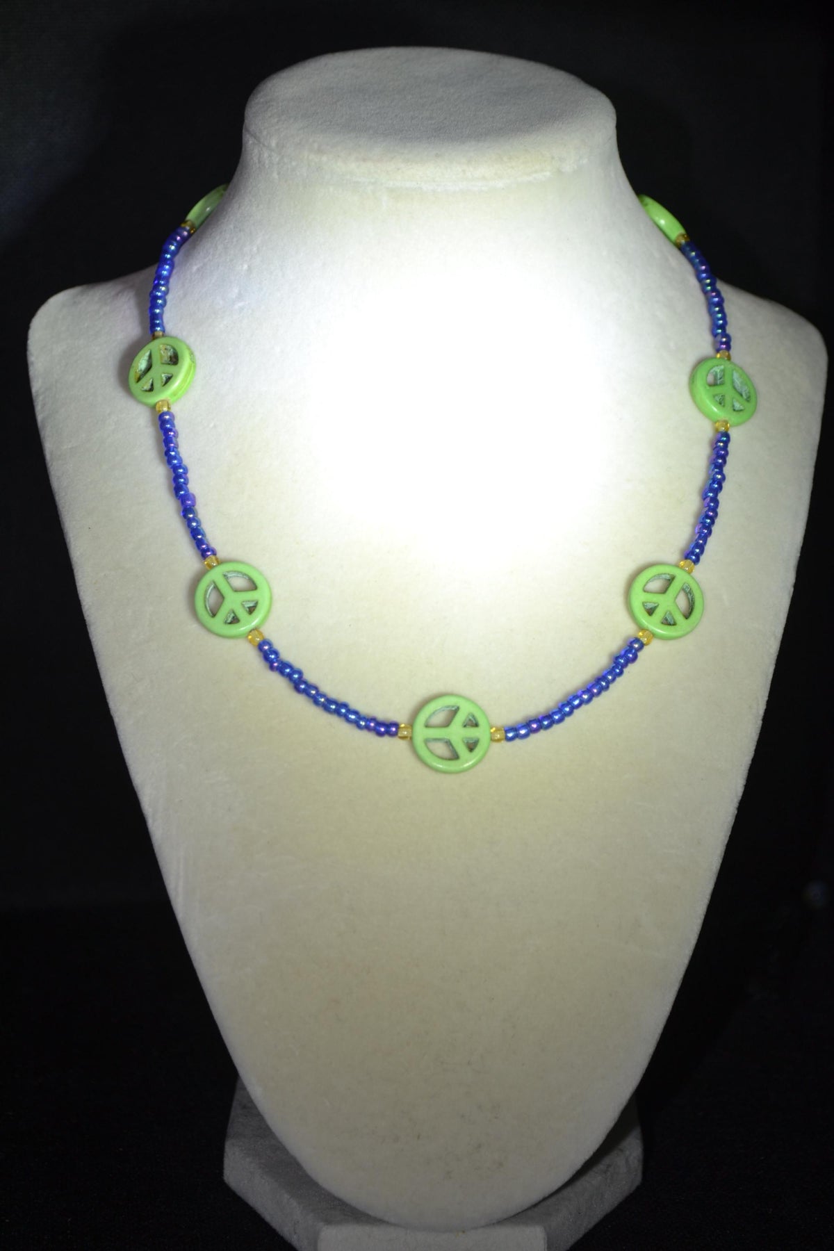 Multicolor glass bead necklace. Green peace sign, blue, and amber