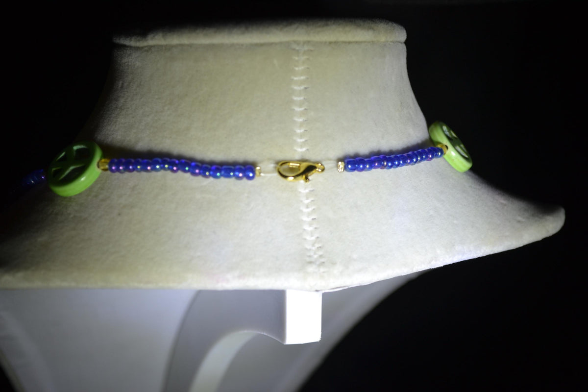 Multicolor glass bead necklace. Green peace sign, blue, and amber