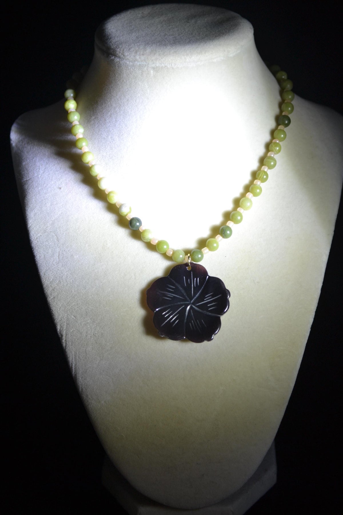 Carved Plumeria pendant glass bead necklace. Green jade and sand