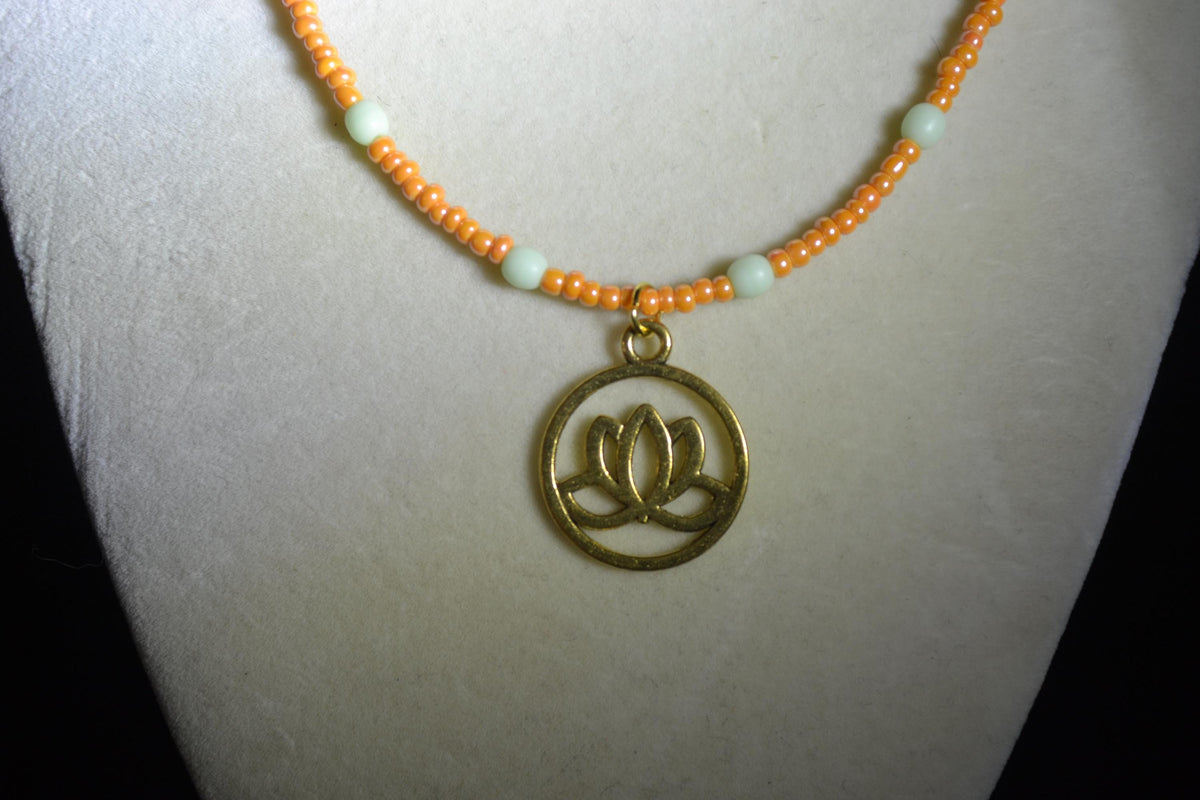 Gold Lotus pendant glass bead necklace. Mint and tangerine