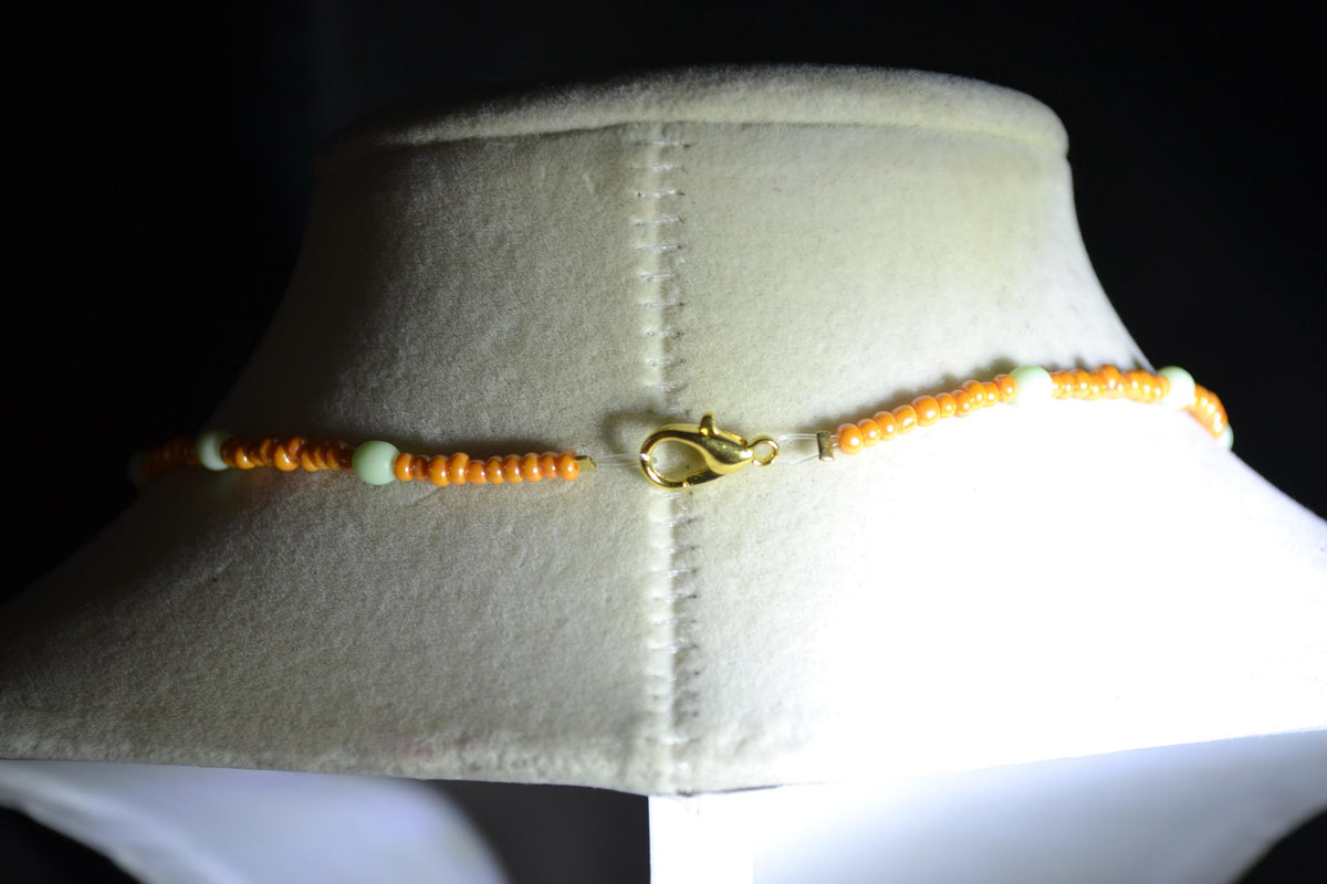 Gold Lotus pendant glass bead necklace. Mint and tangerine