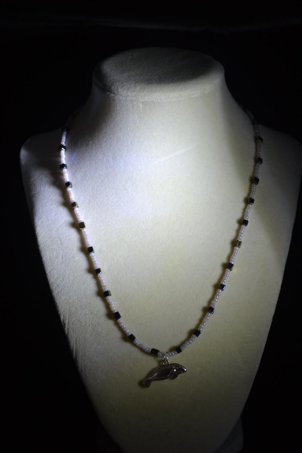Silver Manatee pendant glass bead necklace. Gray, blue, and gold