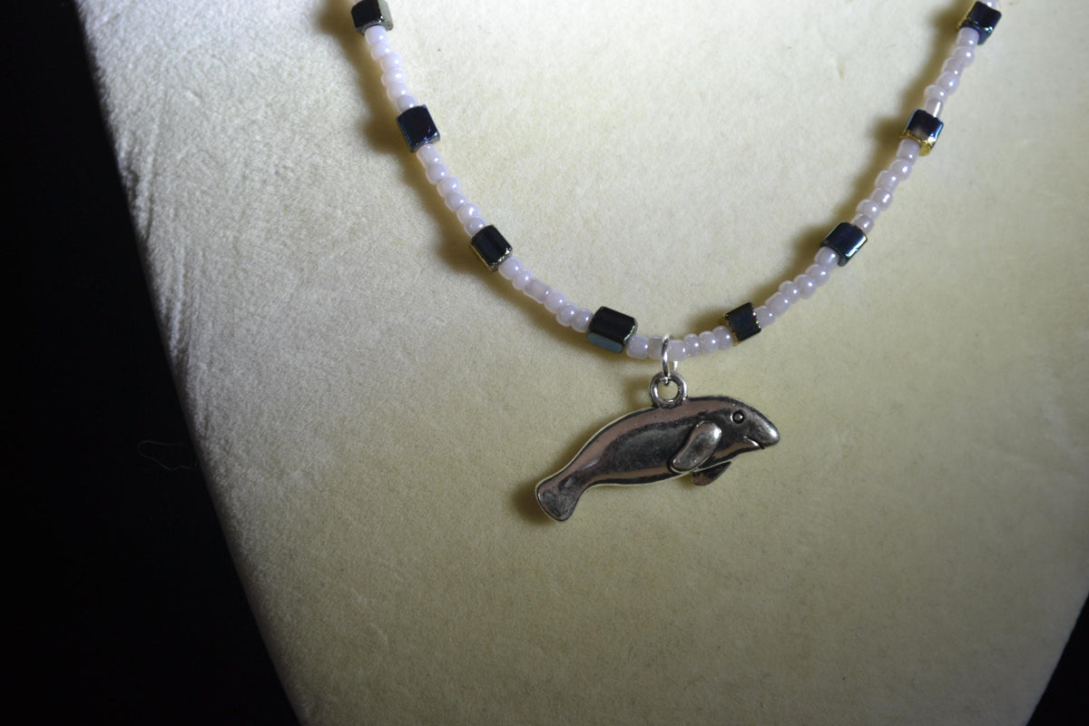 Silver Manatee pendant glass bead necklace. Gray, blue, and gold