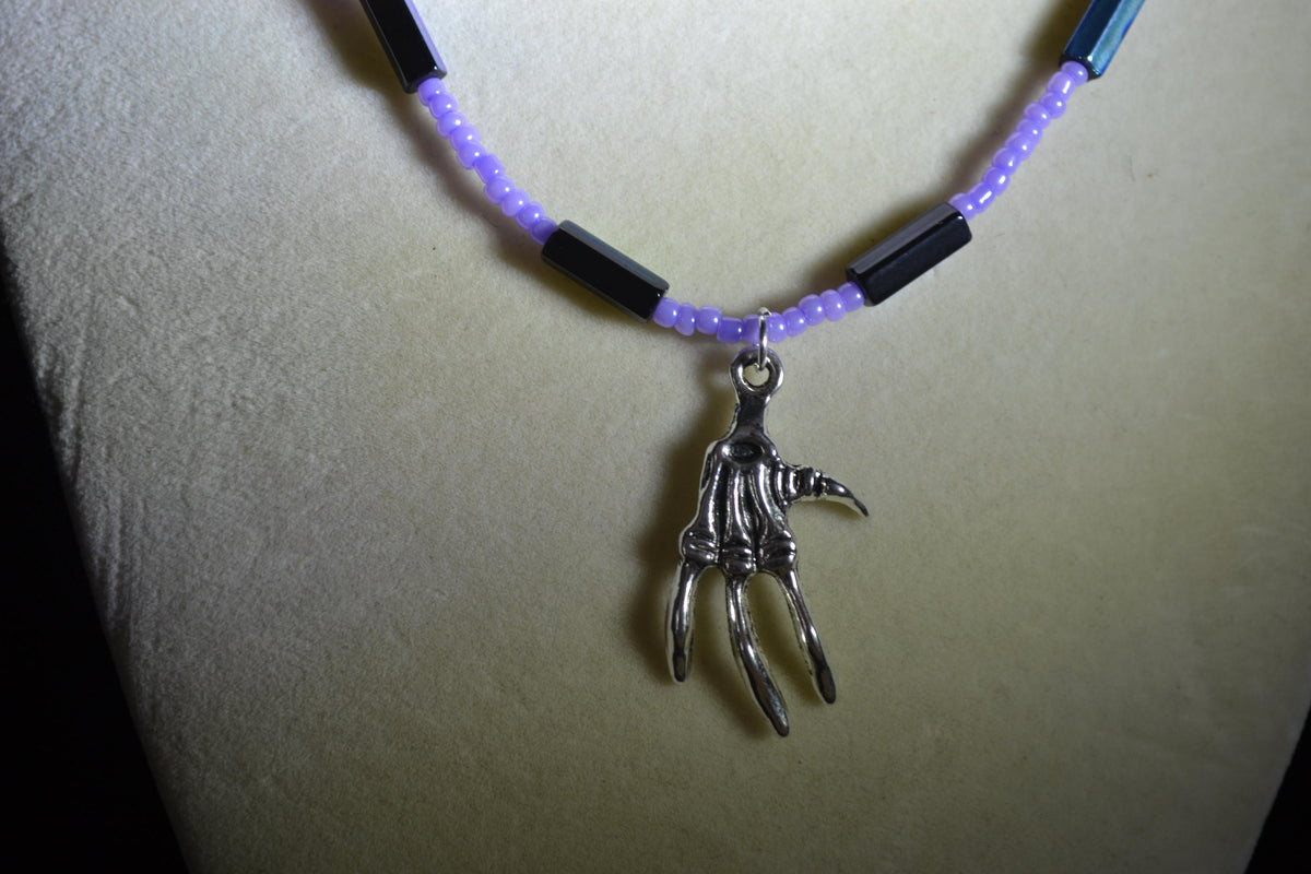 Silver talon skeleton pendant glass bead necklace. Lavender and metallic black