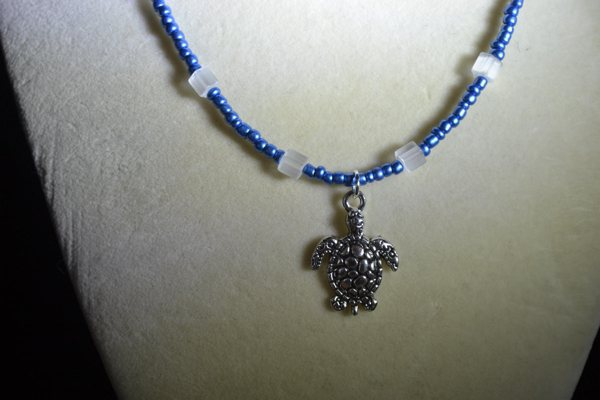 Silver Turtle pendant glass bead necklace. Metallic blue and cat eye