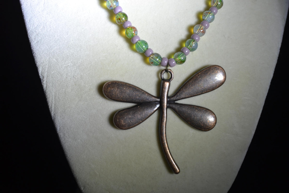 Bronze Dragonfly pendant glass bead necklace. Green and purple