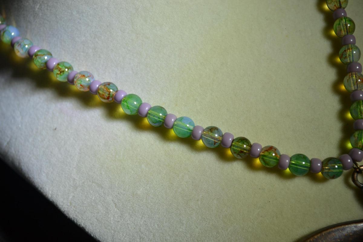Bronze Dragonfly pendant glass bead necklace. Green and purple