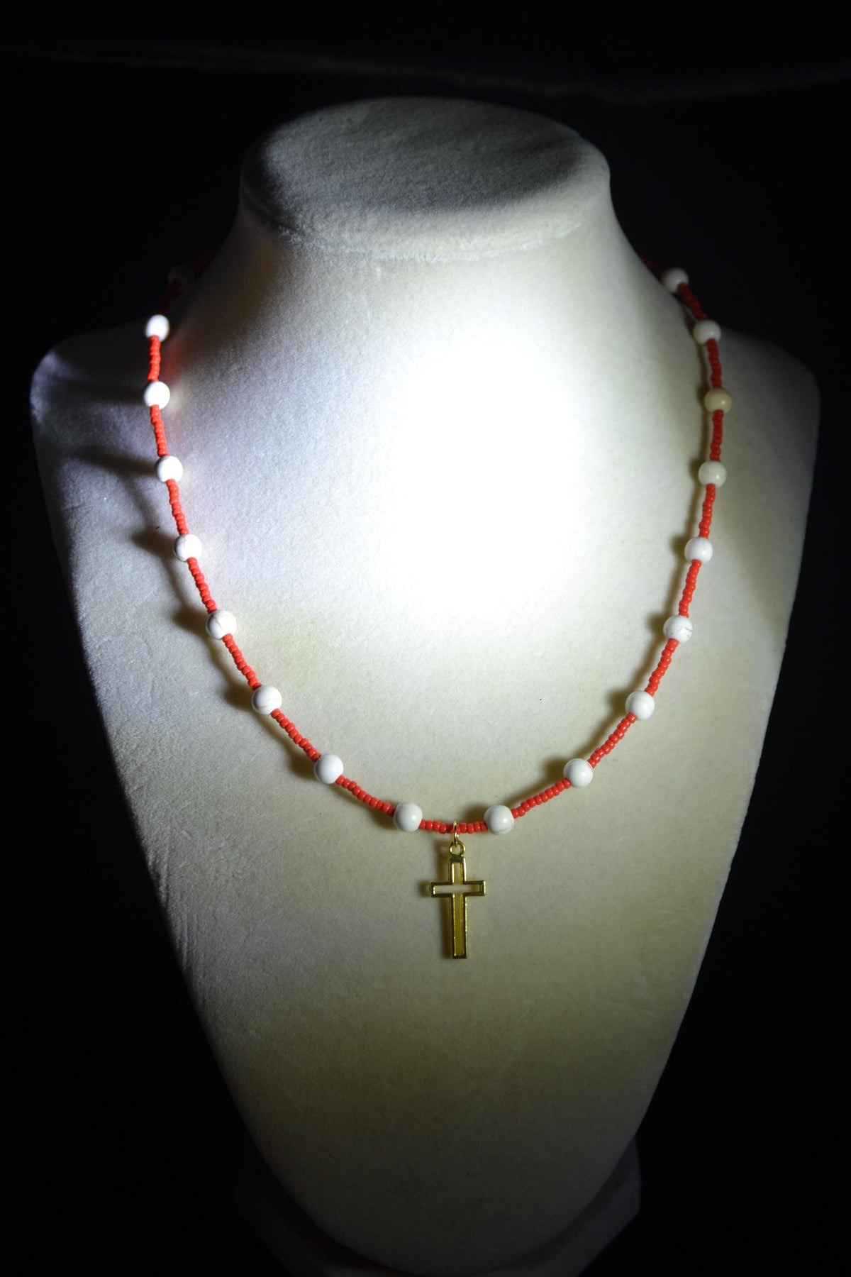 Gold cross pendant glass bead necklace. Red and white
