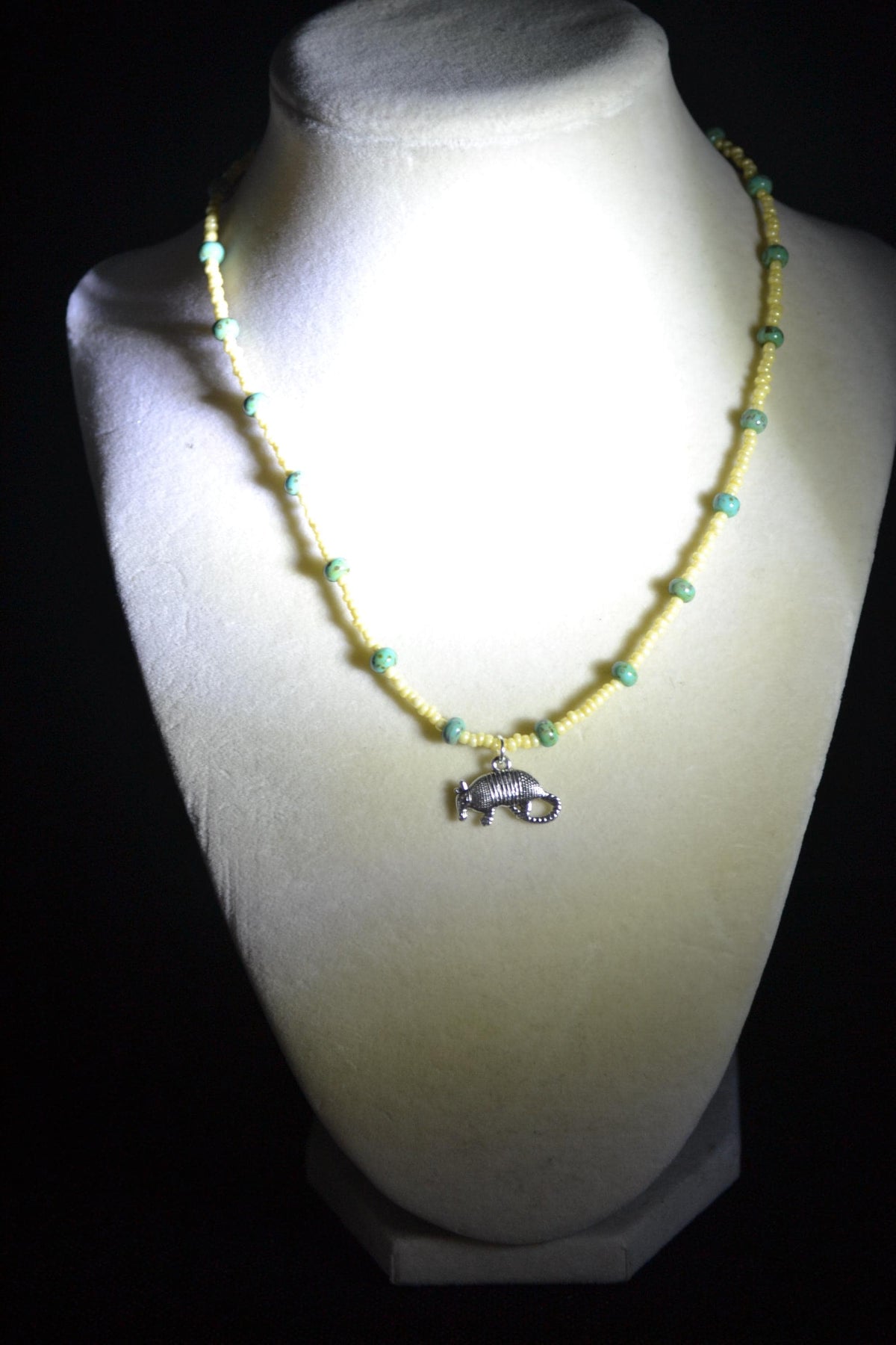 Silver Armadillo pendant glass bead necklace. Yellow and turquoise