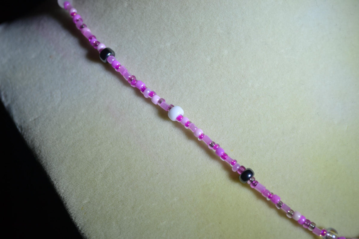 Silver Playboy pendant glass bead necklace. Mixed pinks
