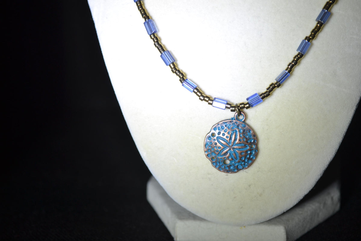 Bronze Sand dollar pendant glass bead necklace. Blue and bronze