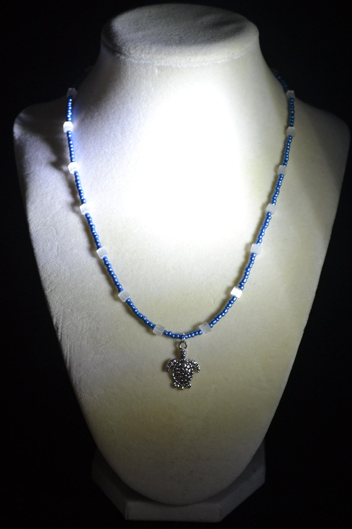 Silver Turtle pendant glass bead necklace. Metallic blue and cat eye