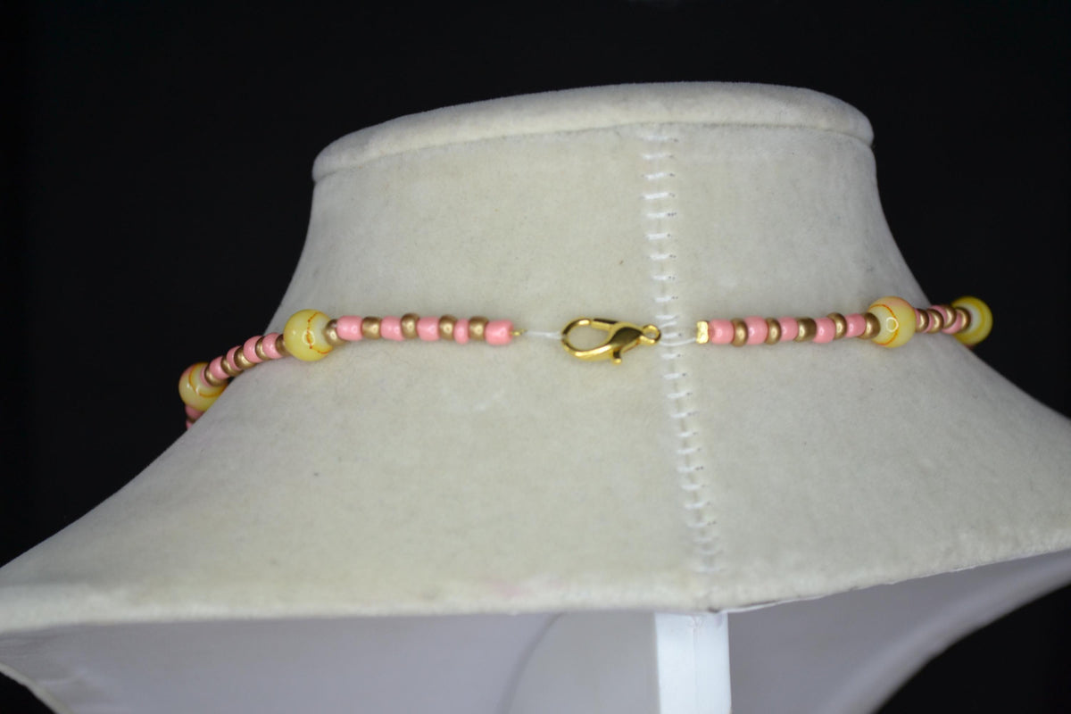 Gold Brass bubble pendant glass bead necklace. Coral, gold, and yellow tie dye