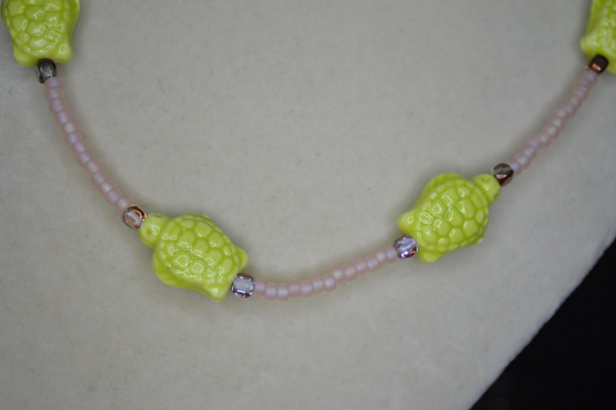Beaded Sea Turtle necklace. Frosted pink, amber, and green
