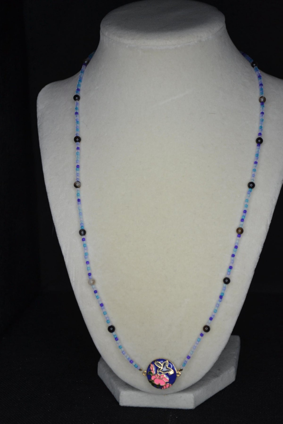Gold Hummingbird pendant glass bead necklace. Blues and black agate