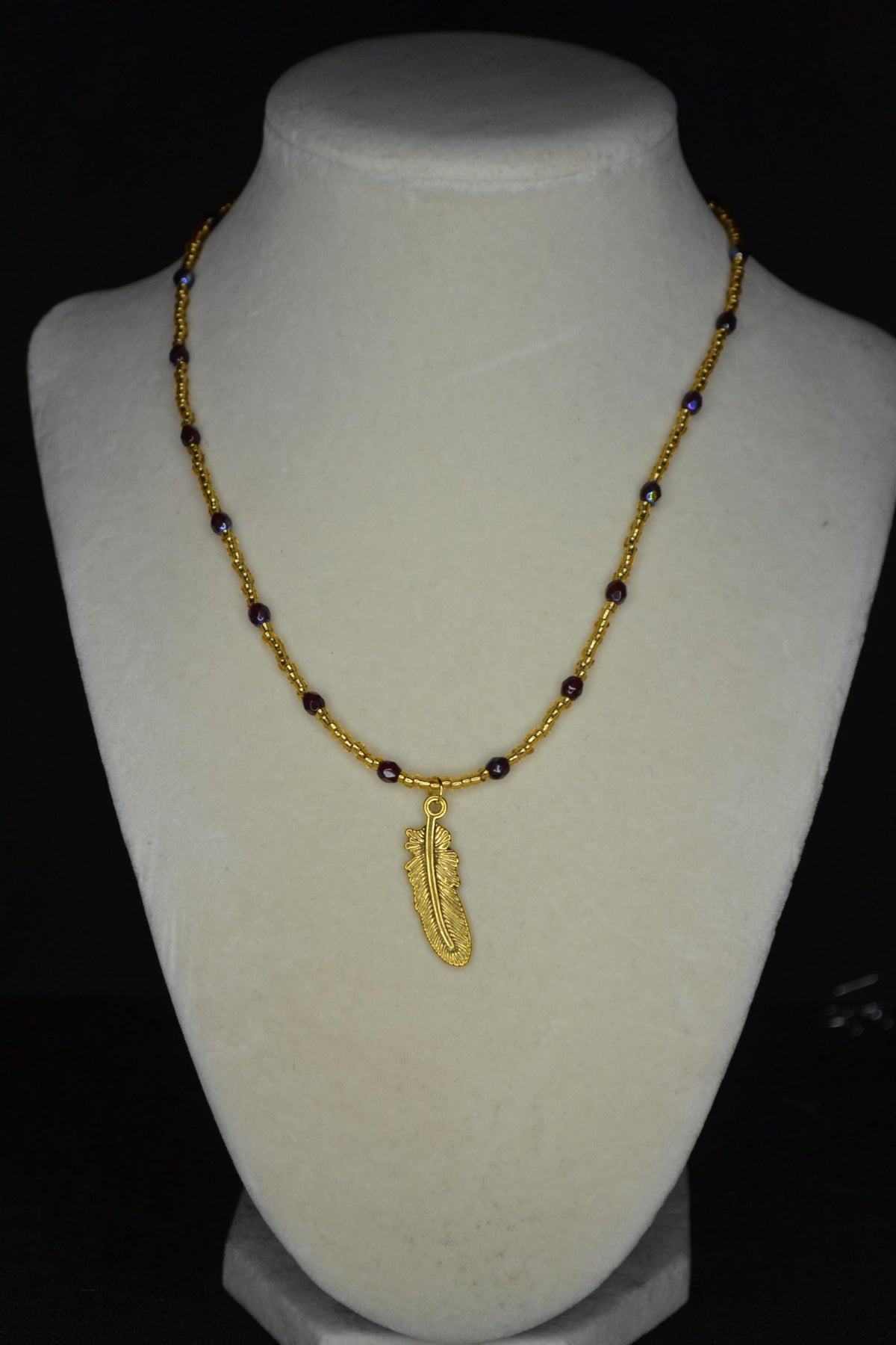Gold feather pendant glass bead necklace. Garnet and gold. FSU