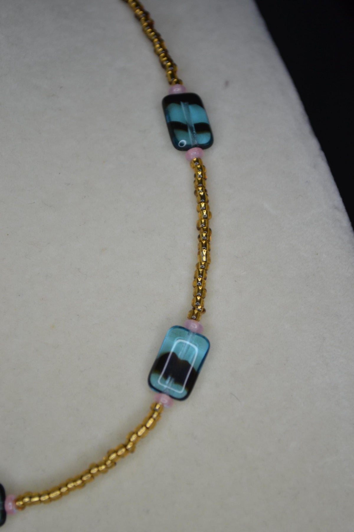 Multicolor glass bead necklace. Blue tortoise, brown, and iridescent pink