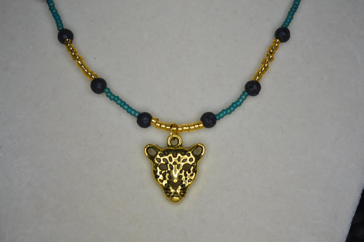 Gold Jaguar pendant glass bead necklace. Teal, gold, and lava rock