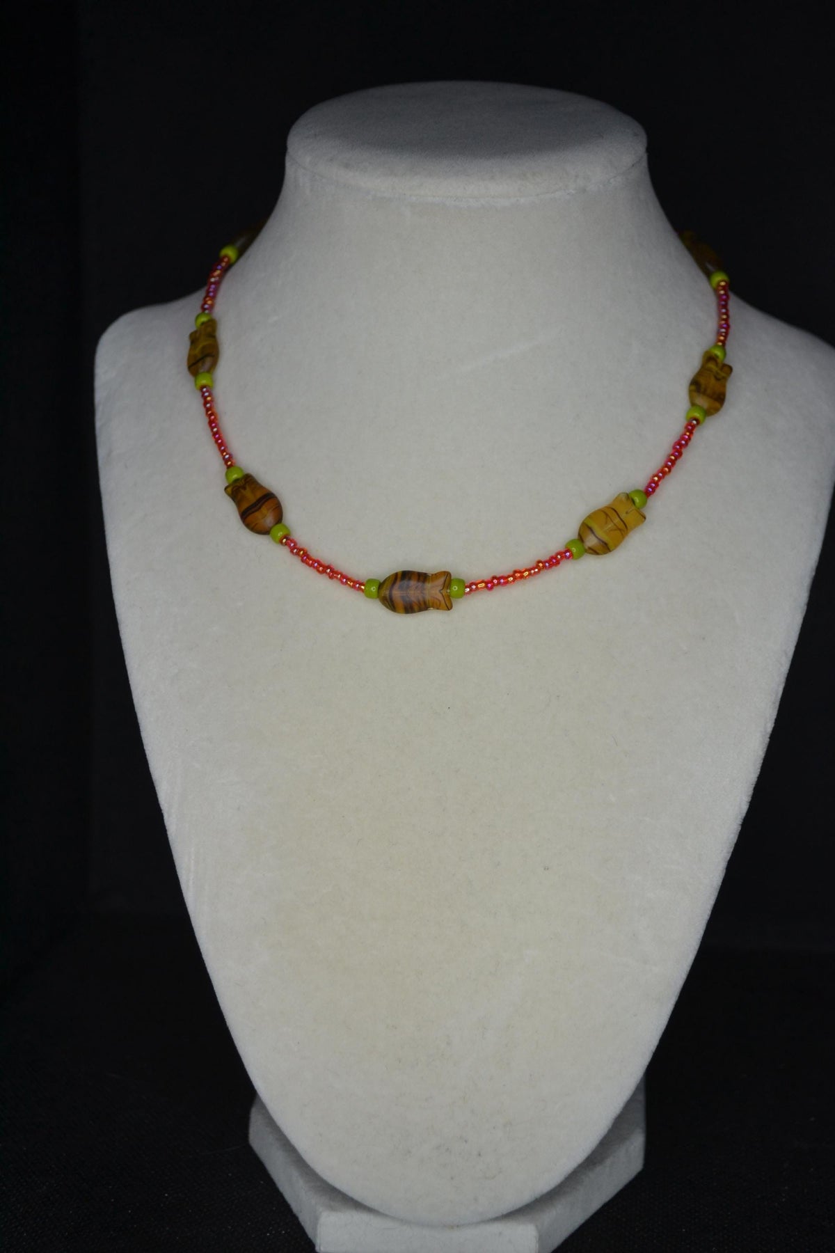 Beaded fish choker. Raspberry, olive, and topaz