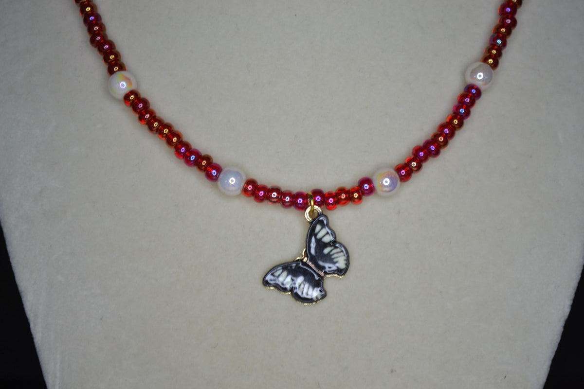 Black Butterfly pendant glass bead necklace. Pearl and red