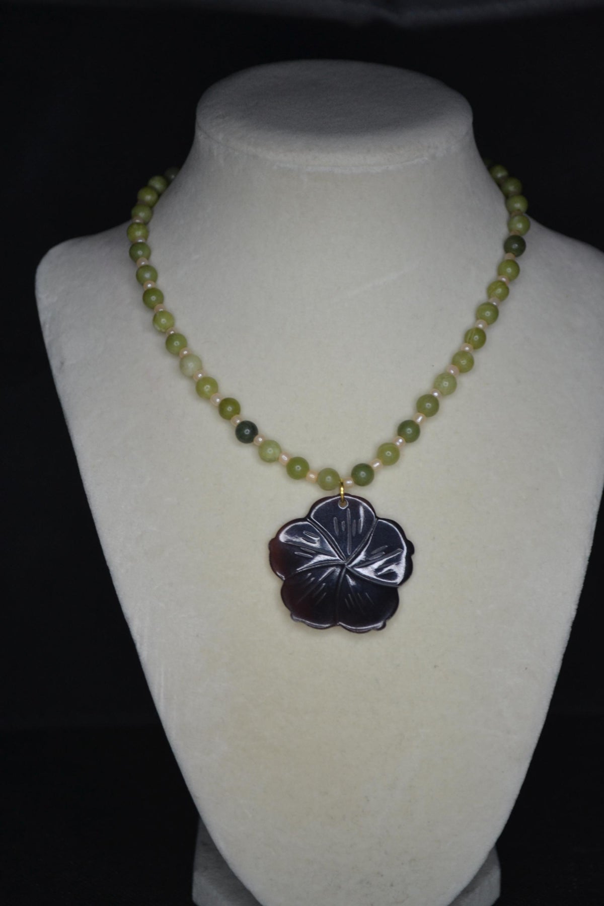 Carved Plumeria pendant glass bead necklace. Green jade and sand