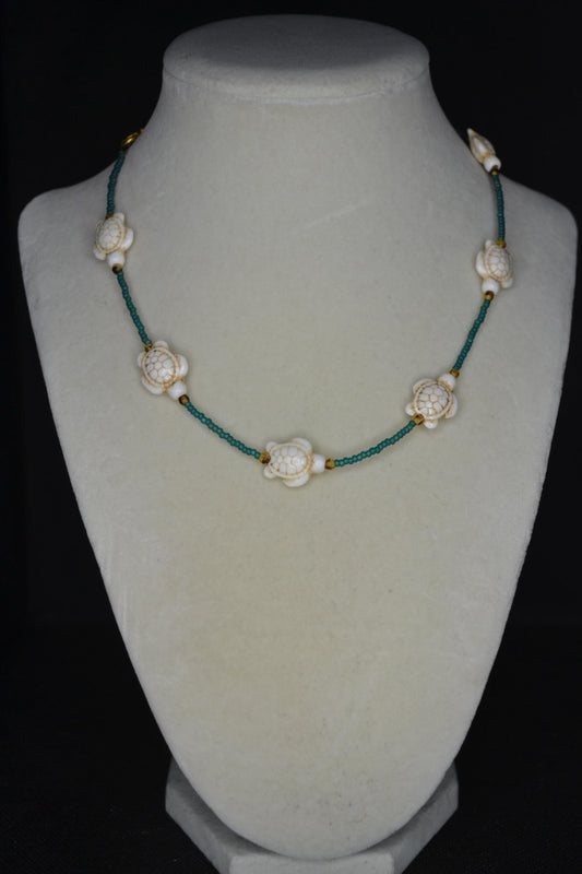 Multicolor glass bead necklace. White turtles, teal, and brown tortoise