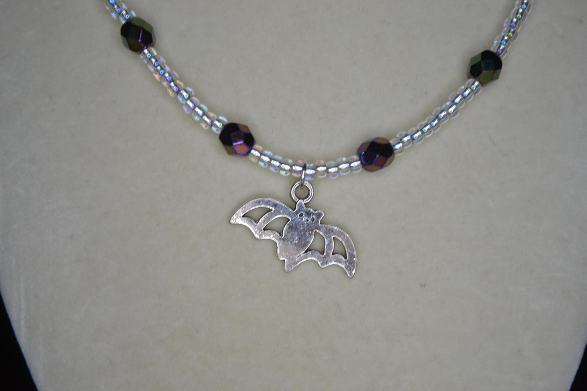Silver Bat pendant glass bead necklace. Metallic black and crystal