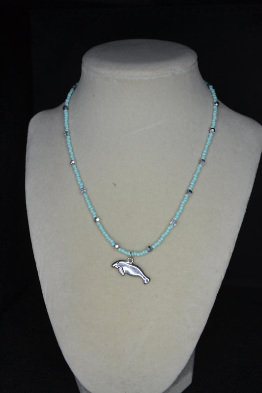 Silver Manatee pendant glass bead necklace. Aqua and silver