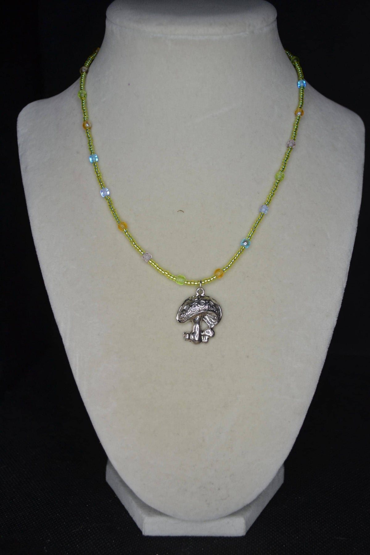 Silver mushroom pendant glass bead necklace. Green, blue, purple, and orange