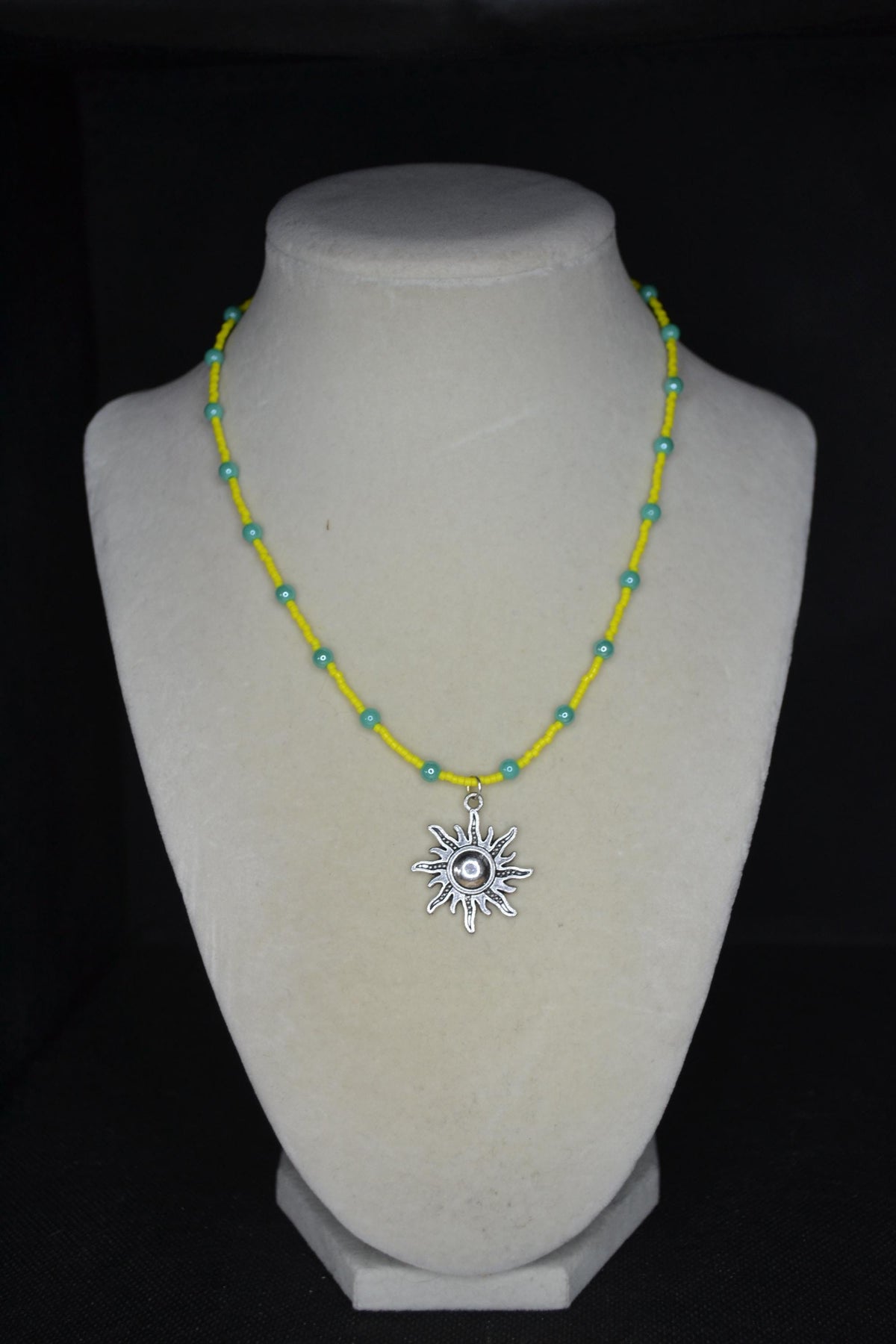 Silver sun pendant glass bead necklace. Yellow and turquoise