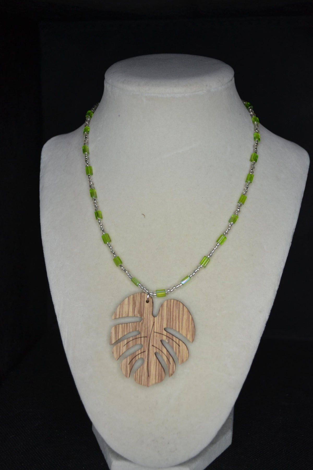 Wooden Monstera pendant glass bead necklace. Green and silver