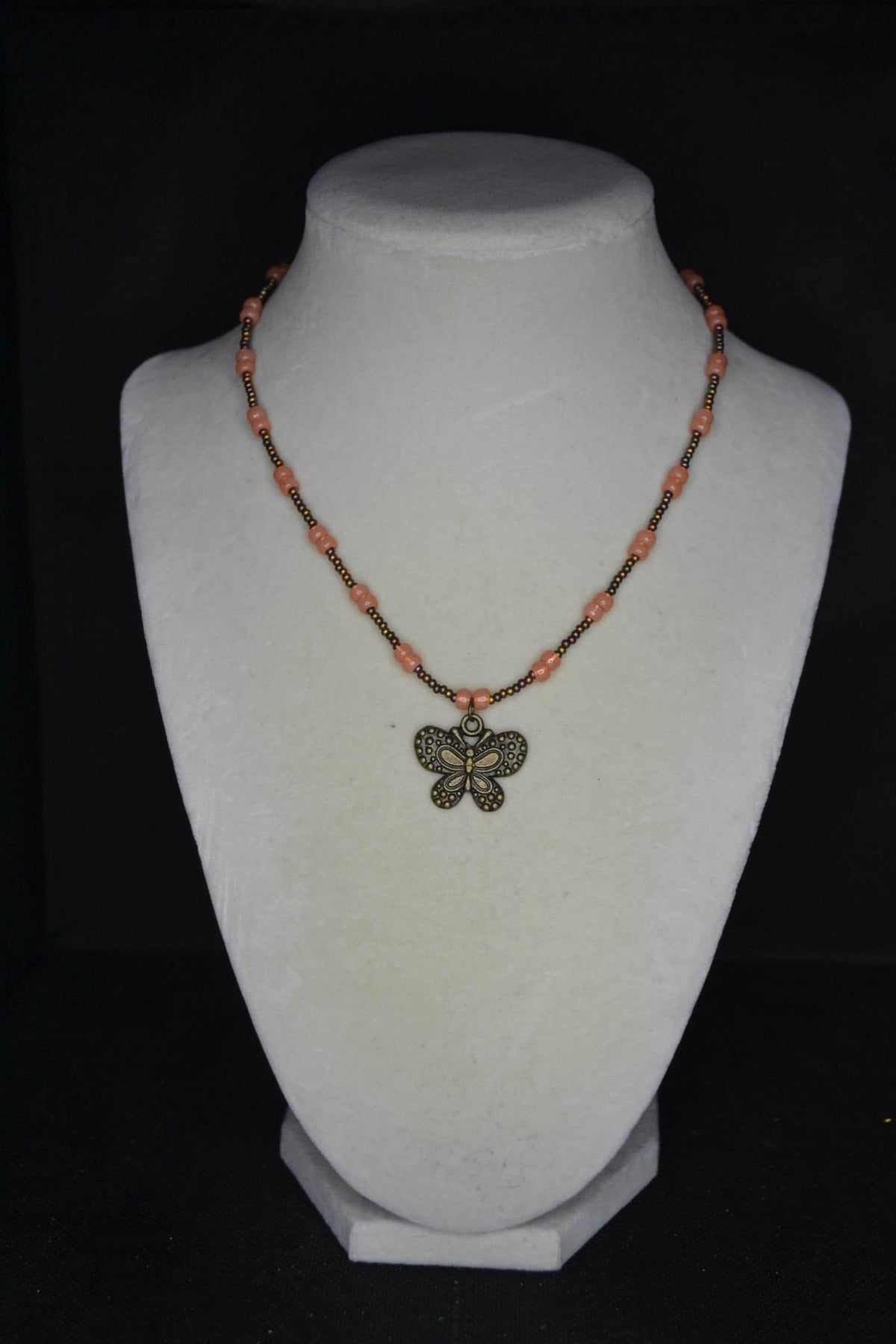 Bronze butterfly pendant glass bead necklace. Bronzes and coral