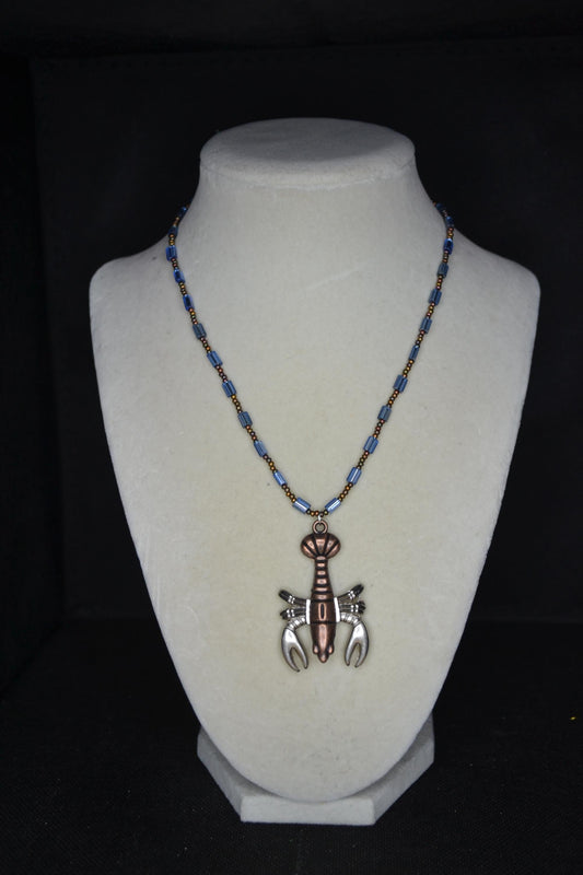 Bronze lobster pendant glass bead necklace. Mixed bronzes and blue