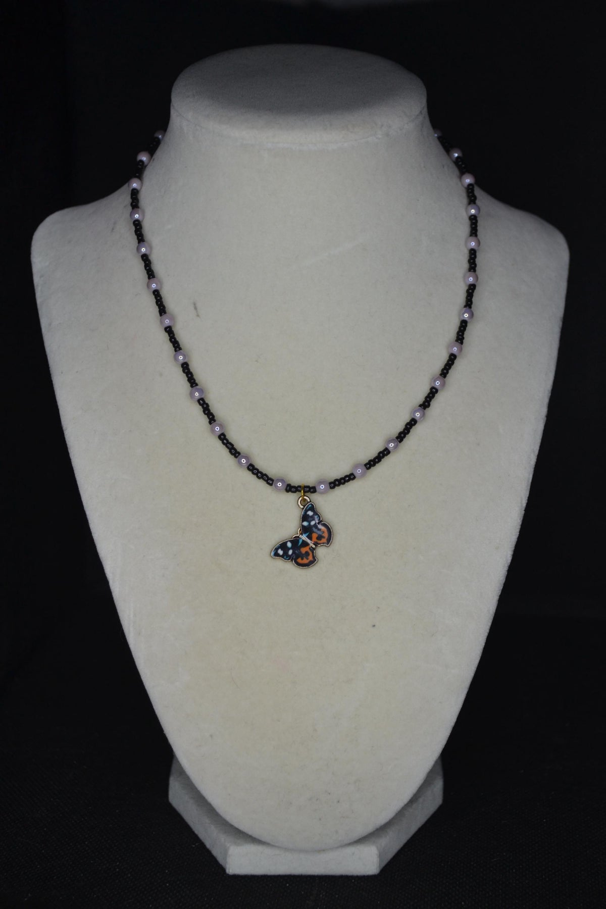 Butterfly pendant glass bead necklace. Purple and black