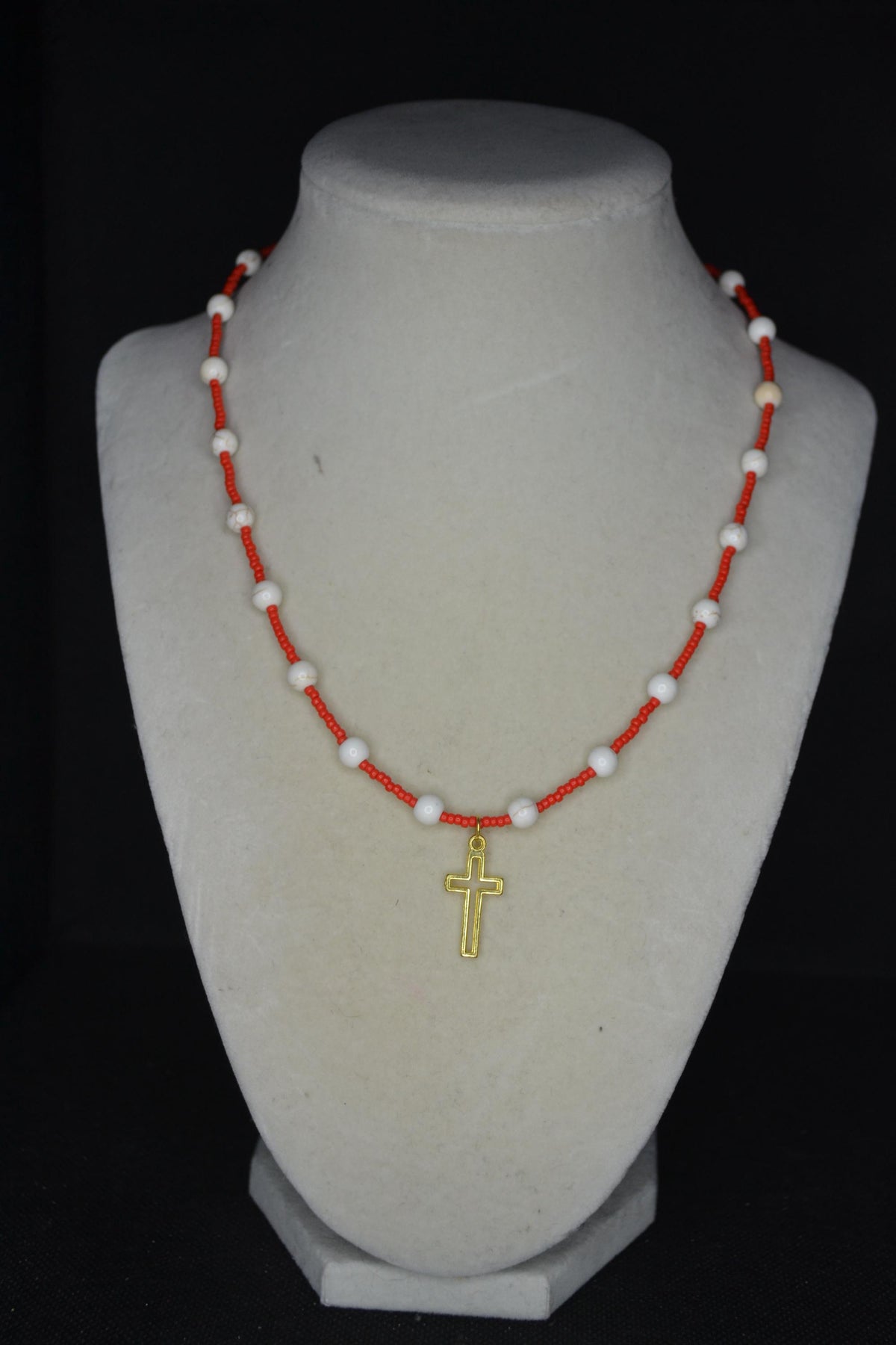Gold cross pendant glass bead necklace. Red and white