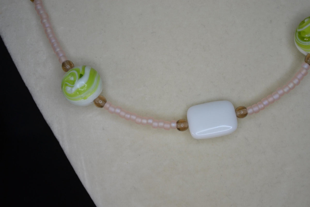 Multicolor glass bead necklace. Frosted rose, green swirls, and white tiles.