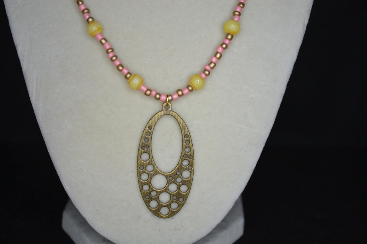 Gold Brass bubble pendant glass bead necklace. Coral, gold, and yellow tie dye