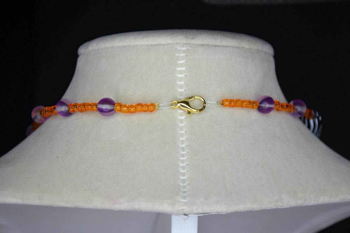 Multicolor glass and wood bead necklace. Orange, frosted purple, and black and white stripes